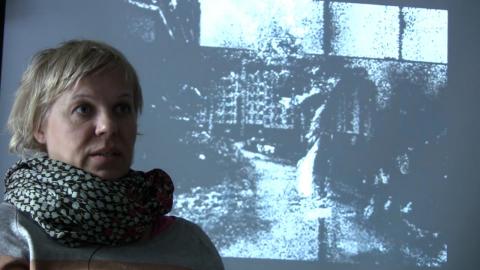 Mia Mäkelä interviewed in front of projection